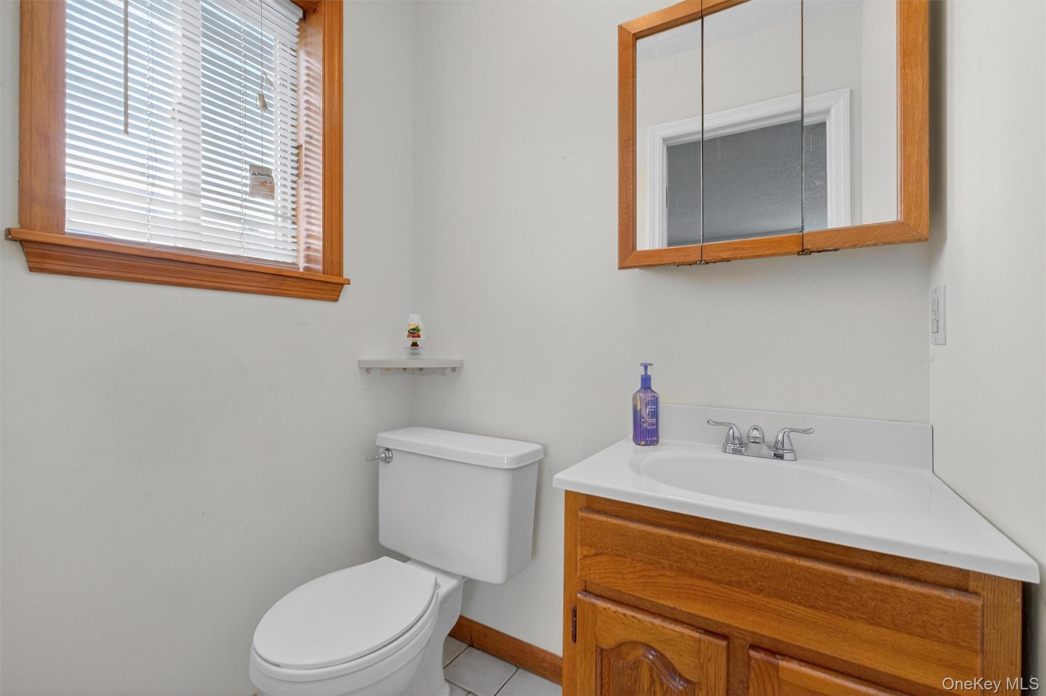 26 Cooper Road, Unit 715 Poughkeepsie, NY 12603 - Photo 20 of 28 a bathroom with a toilet sink and mirror