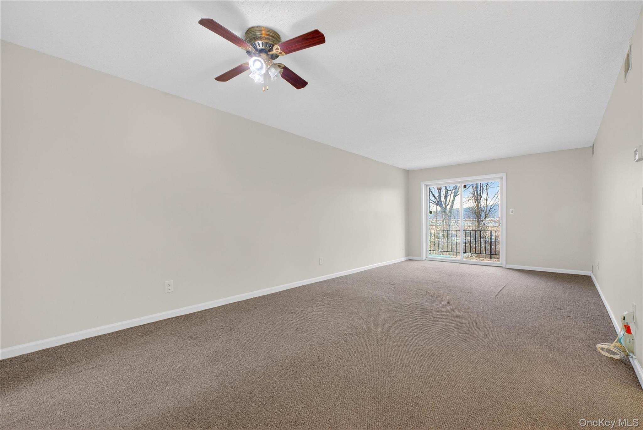 26 Cooper Road, Unit 715 Poughkeepsie, NY 12603 - Photo 6 of 30 an empty room with a empty space and a ceiling fan