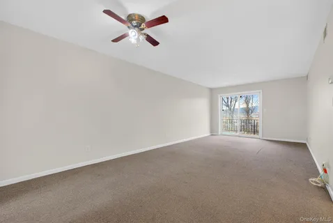 an empty room with a empty space and a ceiling fan