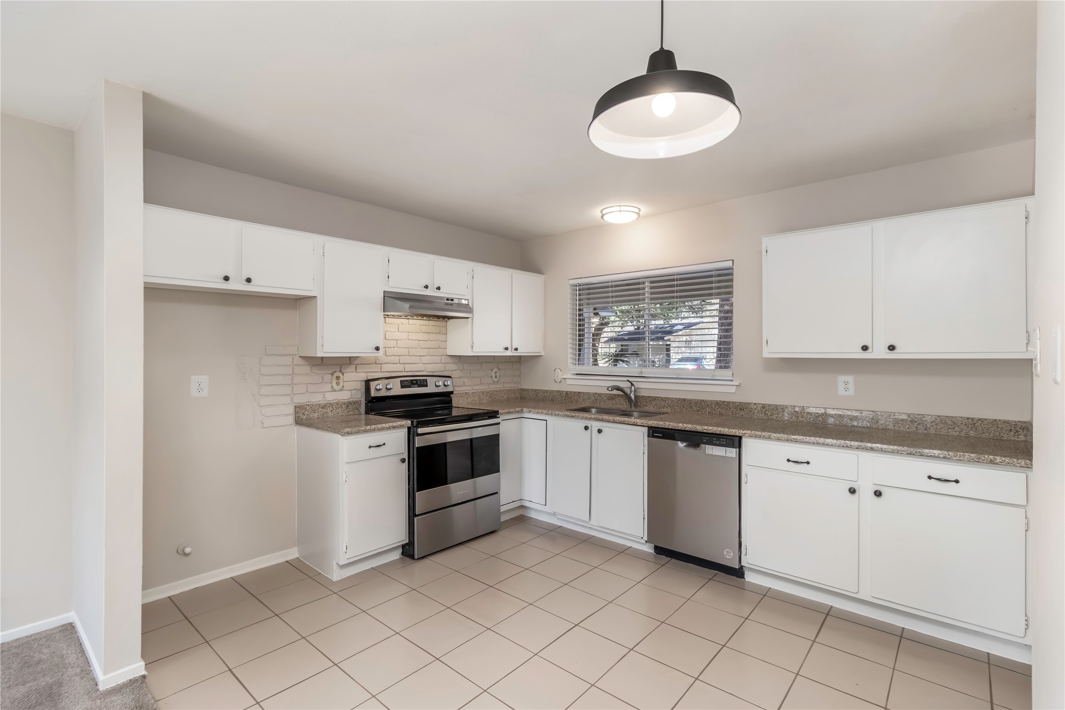 6 Red Deer Lane Spring, TX 77380 - Photo 8 of 24 a kitchen with granite countertop white cabinets and white appliances