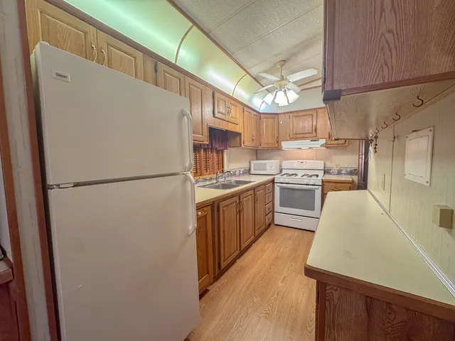 a kitchen with stainless steel appliances granite countertop refrigerator sink and cabinets