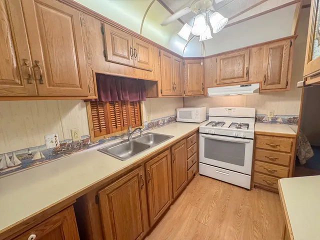 a kitchen with a sink stove and cabinets