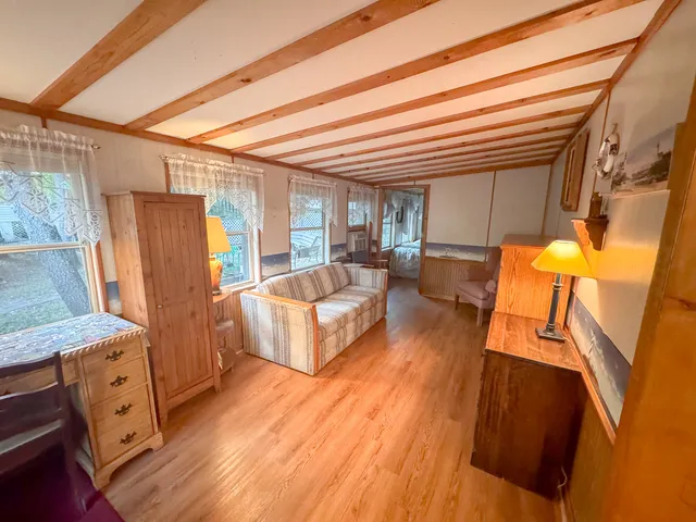 a bedroom with furniture and a wooden floor