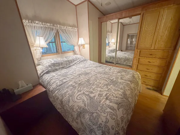 a bedroom with a bed and a window