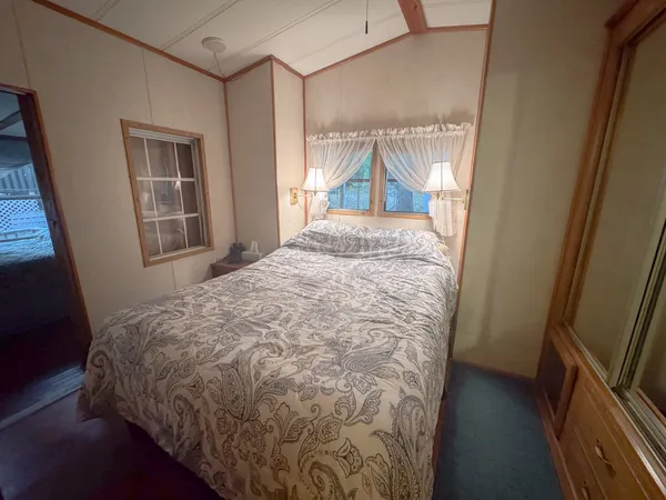 a view of a livingroom with wooden floor and a window