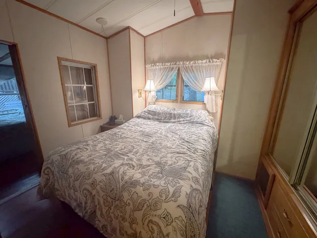 a view of a livingroom with wooden floor and a window