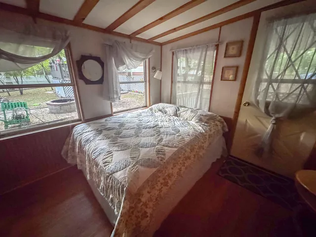 a bed sitting in a bedroom next to a window