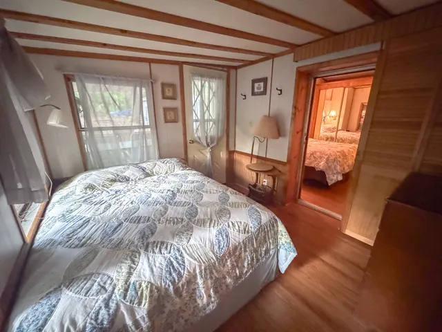 a bed sitting in a bedroom next to a window