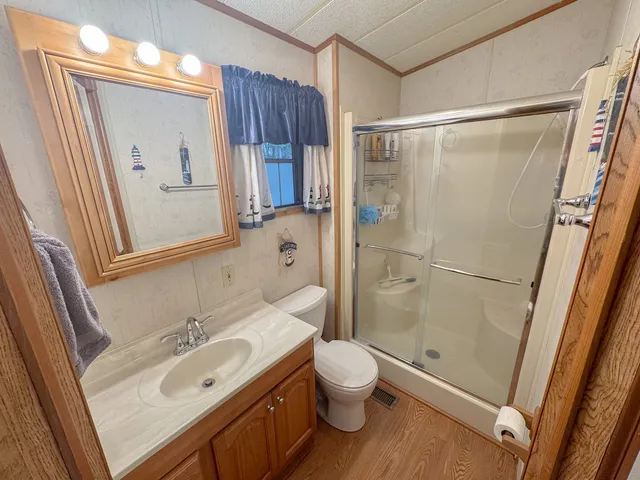a bathroom with a sink toilet and shower