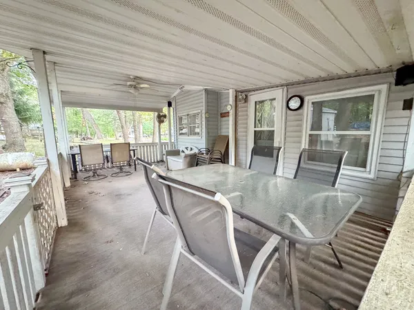 a dining room with furniture a chandelier and wooden floor
