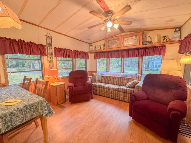 a bedroom with furniture and a large window