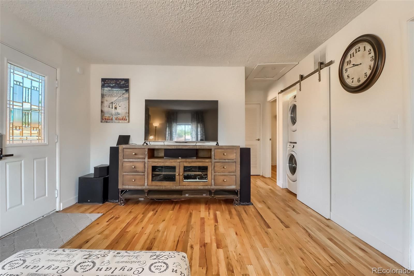 4175 West Custer Place Denver, CO 80219 - Photo 11 of 38 a living room with a furniture and a flat screen tv