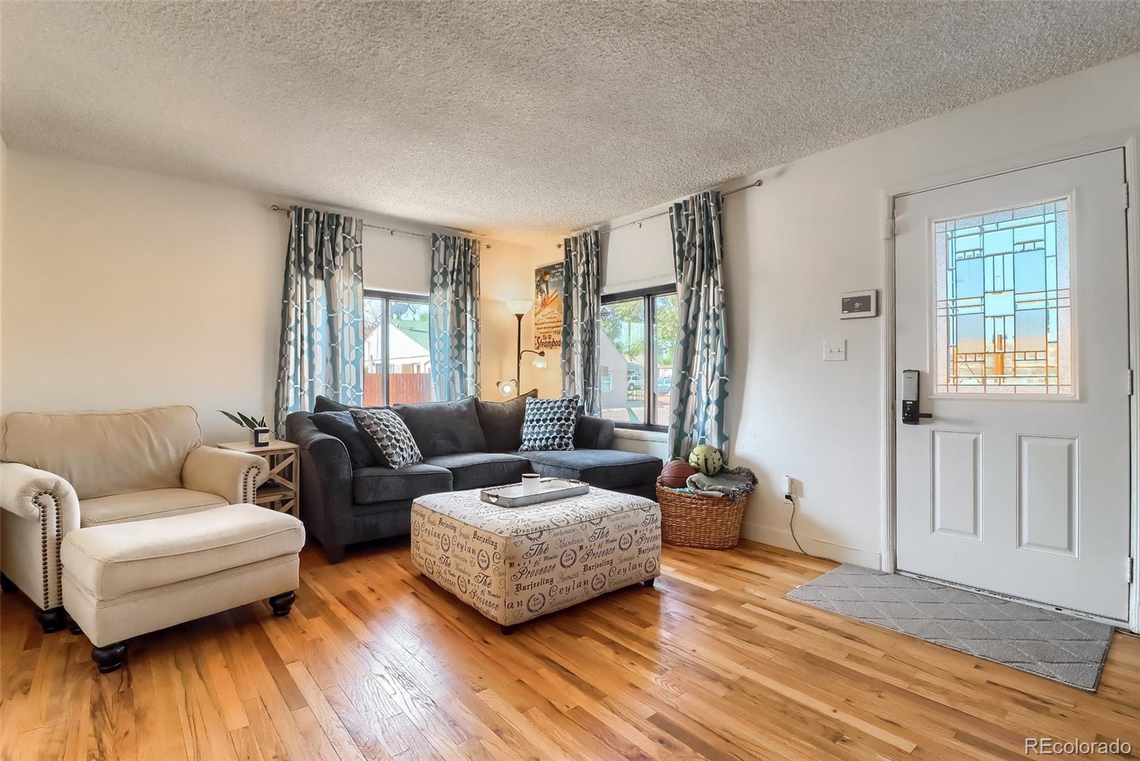 4175 West Custer Place Denver, CO 80219 - Photo 12 of 38 a living room with furniture and a wooden floor
