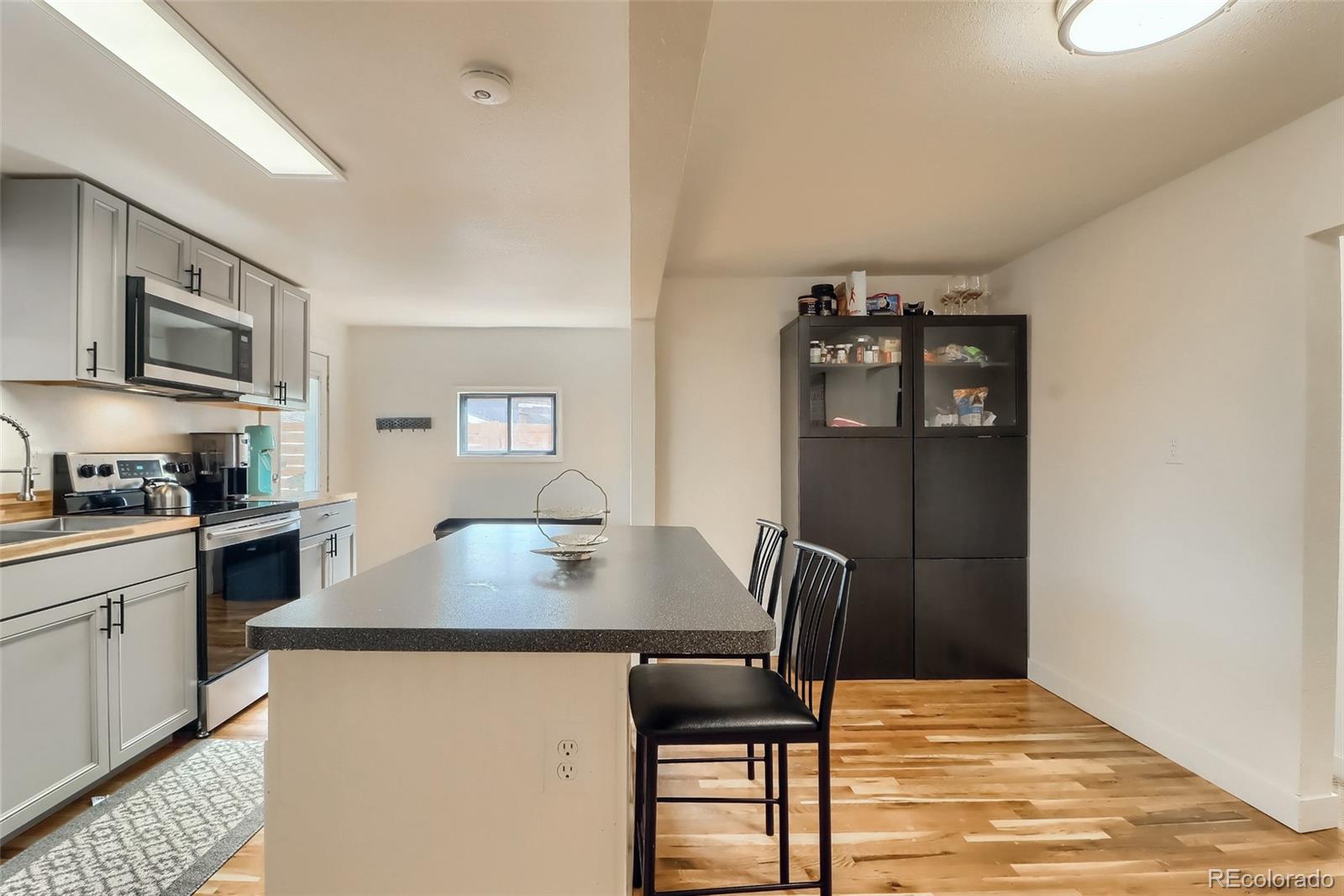 4175 West Custer Place Denver, CO 80219 - Photo 17 of 38 a view of kitchen with cabinets and wooden floor