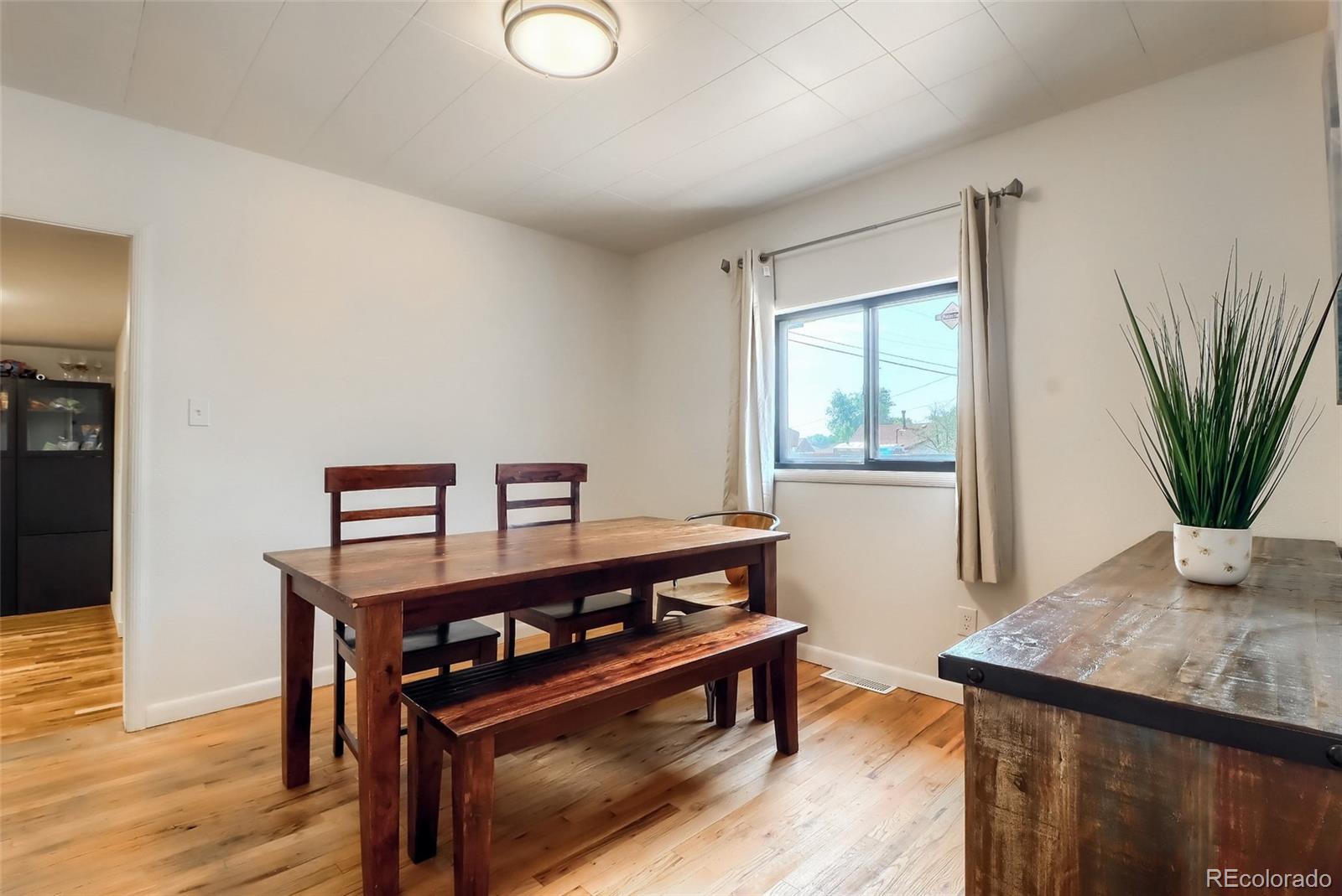 4175 West Custer Place Denver, CO 80219 - Photo 18 of 38 a view of a room with furniture and wooden floor