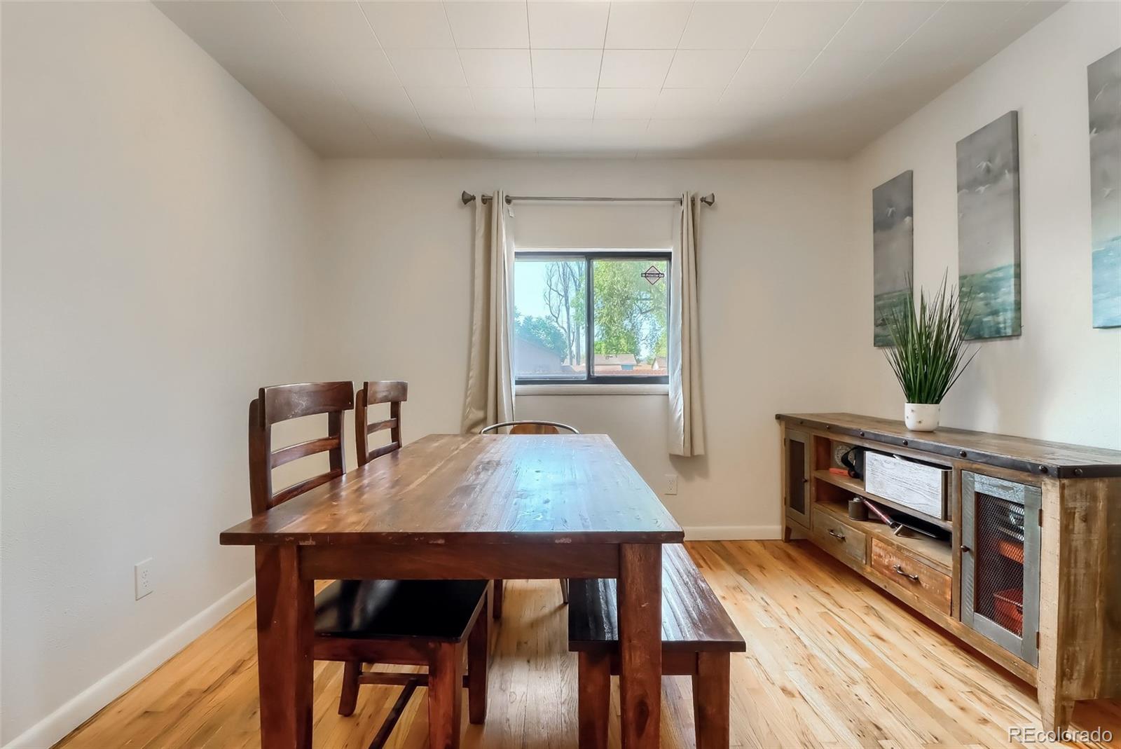 4175 West Custer Place Denver, CO 80219 - Photo 19 of 38 a dining room with furniture and wooden floor