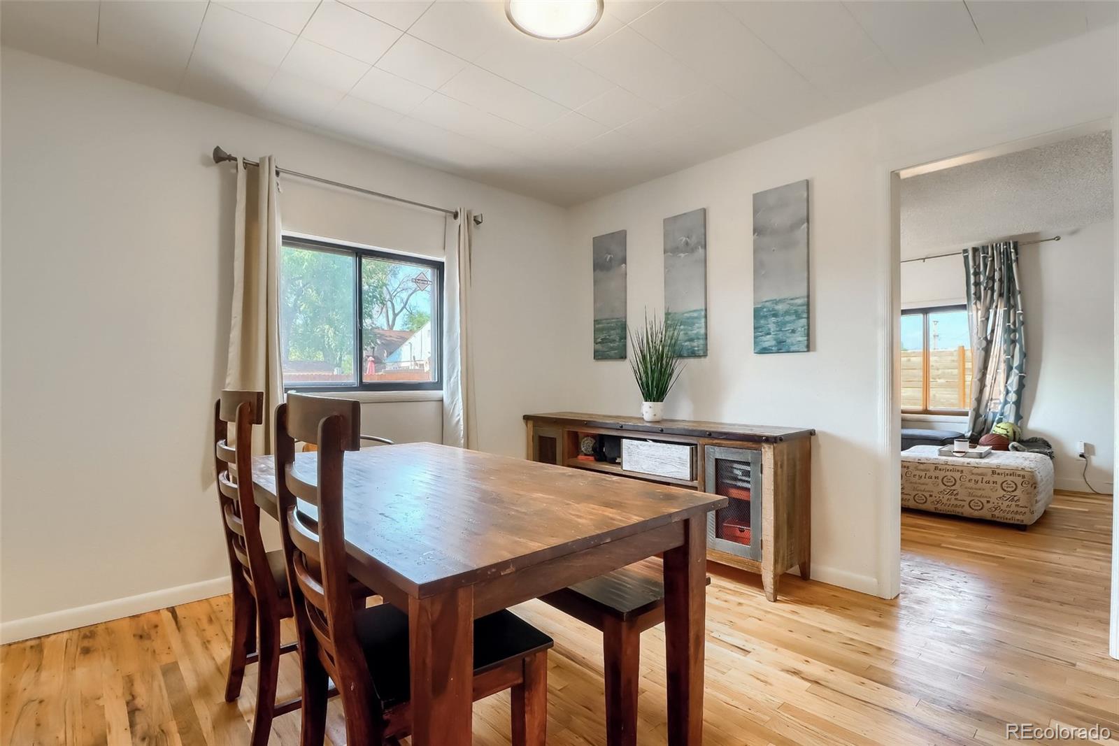 4175 West Custer Place Denver, CO 80219 - Photo 20 of 38 a view of a dining room with furniture and wooden floor