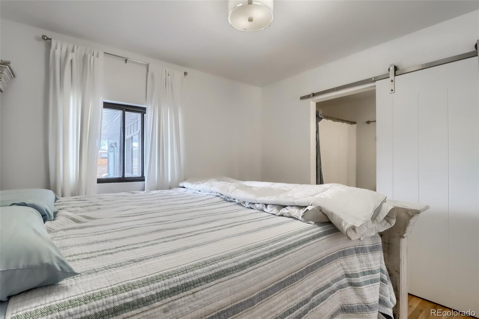 4175 West Custer Place Denver, CO 80219 - Photo 24 of 38 a bedroom with a bed and a window