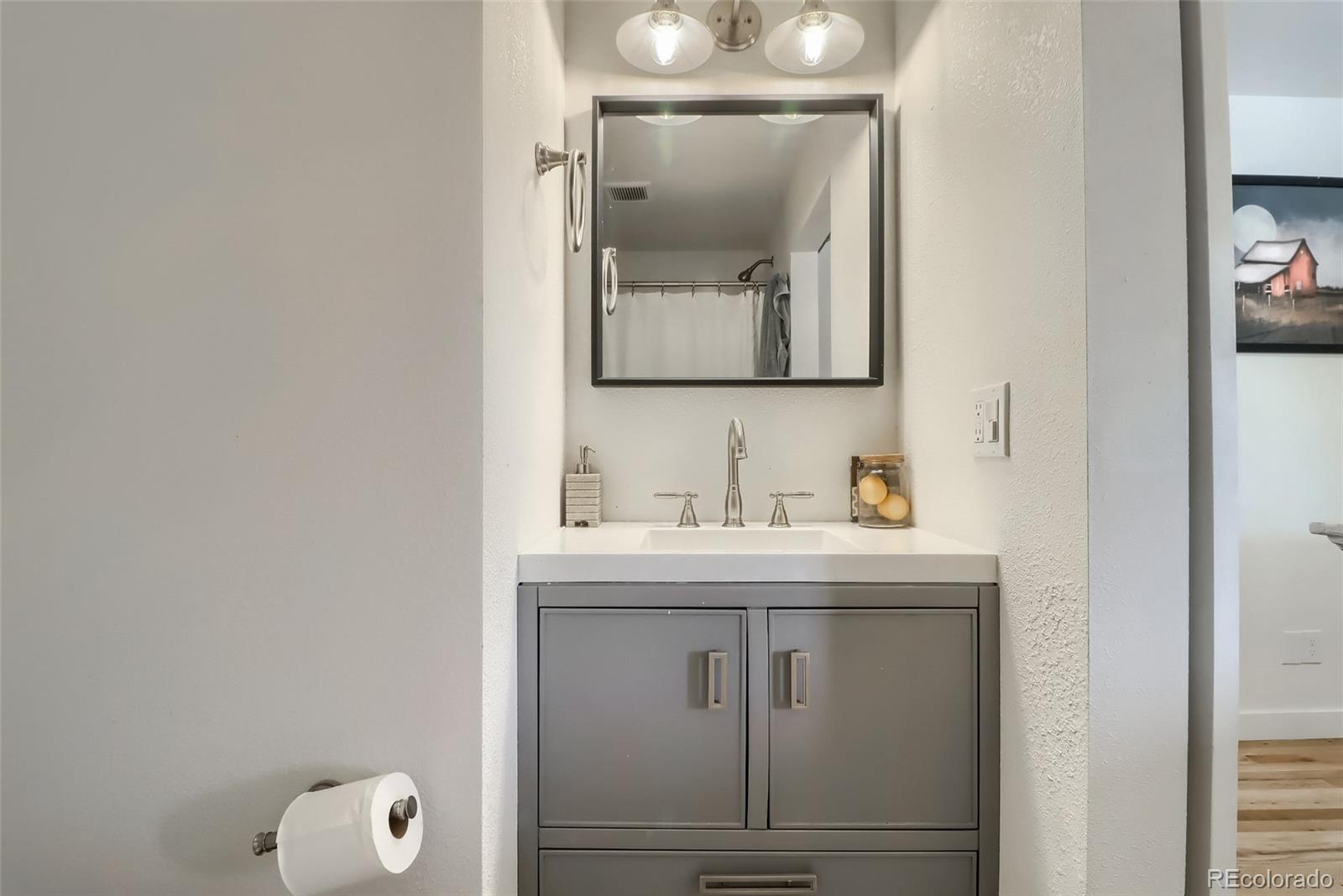 4175 West Custer Place Denver, CO 80219 - Photo 26 of 38 a bathroom with a granite countertop sink and a mirror