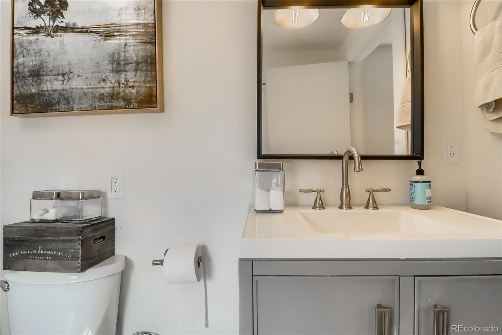 4175 West Custer Place Denver, CO 80219 - Photo 33 of 38 a bathroom with a sink and a mirror