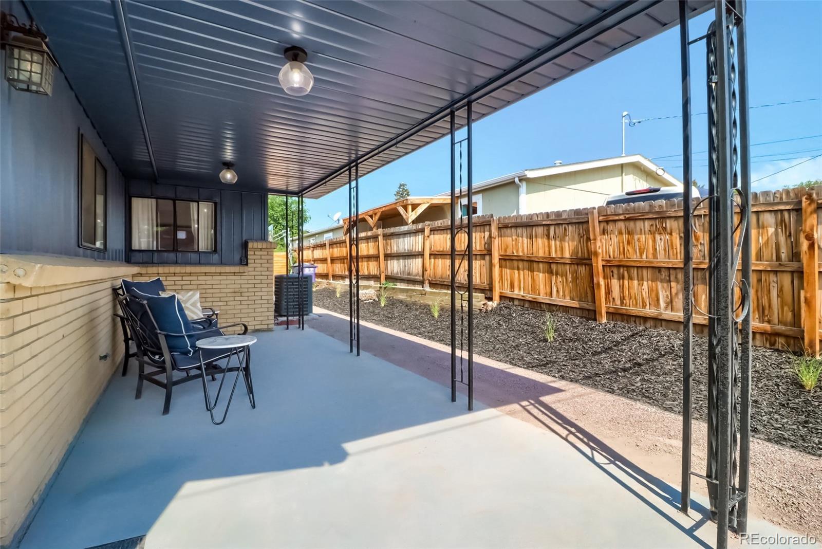 4175 West Custer Place Denver, CO 80219 - Photo 35 of 38 a view of a porch with furniture and a yard