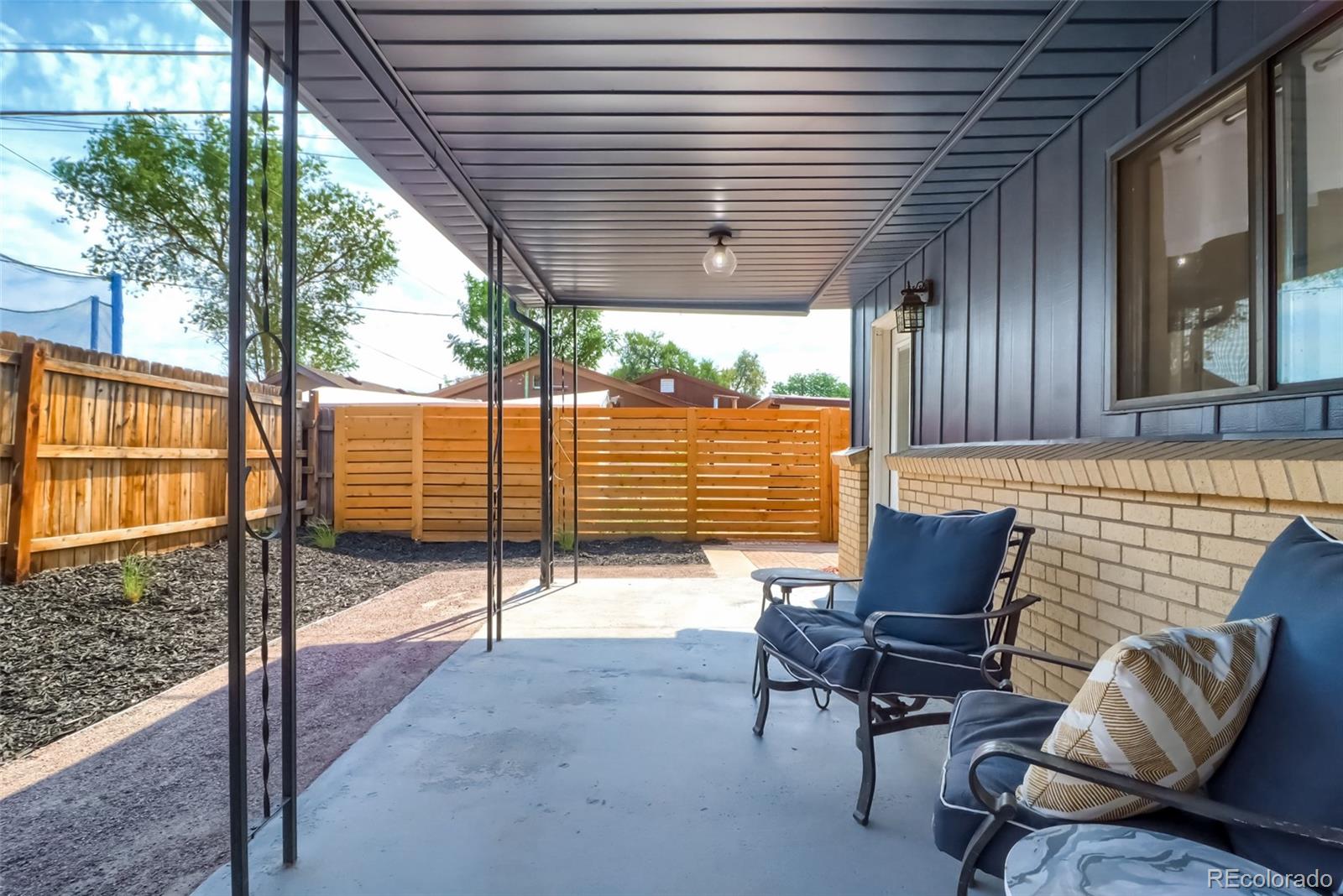 4175 West Custer Place Denver, CO 80219 - Photo 38 of 38 a backyard of a house with wooden floor and outdoor seating