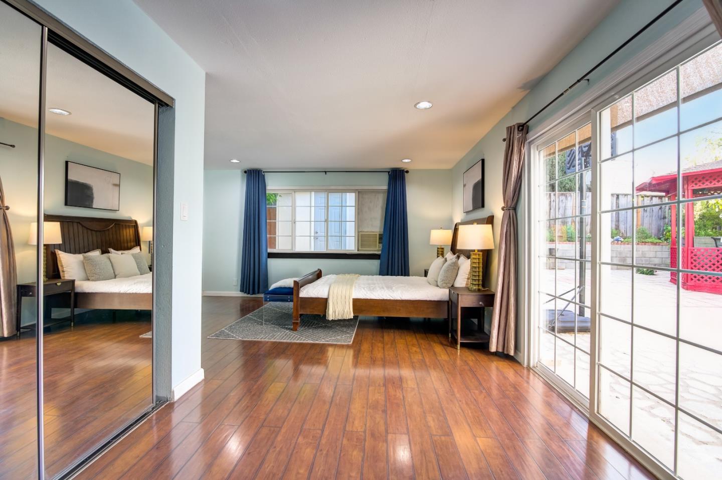 1224 Glacier Drive Milpitas, CA 95035 - Photo 16 of 45 a view of a bedroom with furniture and a large window