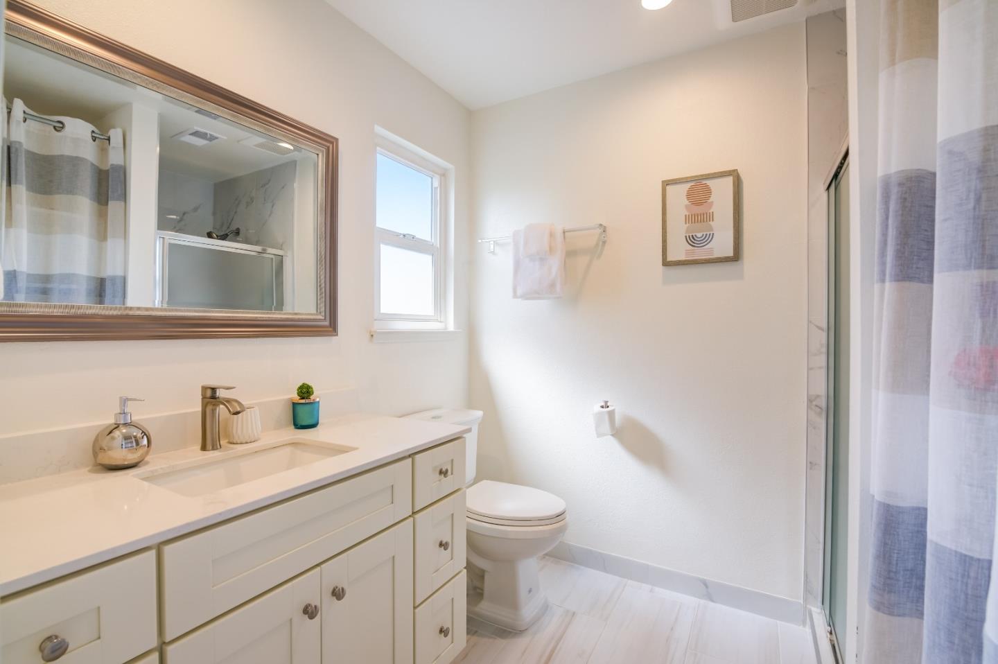 1224 Glacier Drive Milpitas, CA 95035 - Photo 23 of 45 a bathroom with a toilet sink and mirror