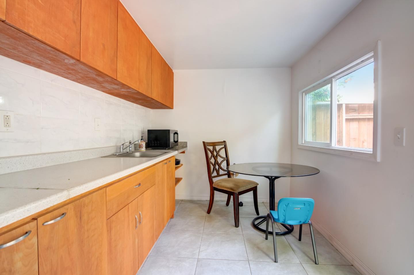1224 Glacier Drive Milpitas, CA 95035 - Photo 25 of 45 a hallway with chairs and a wooden cabinets