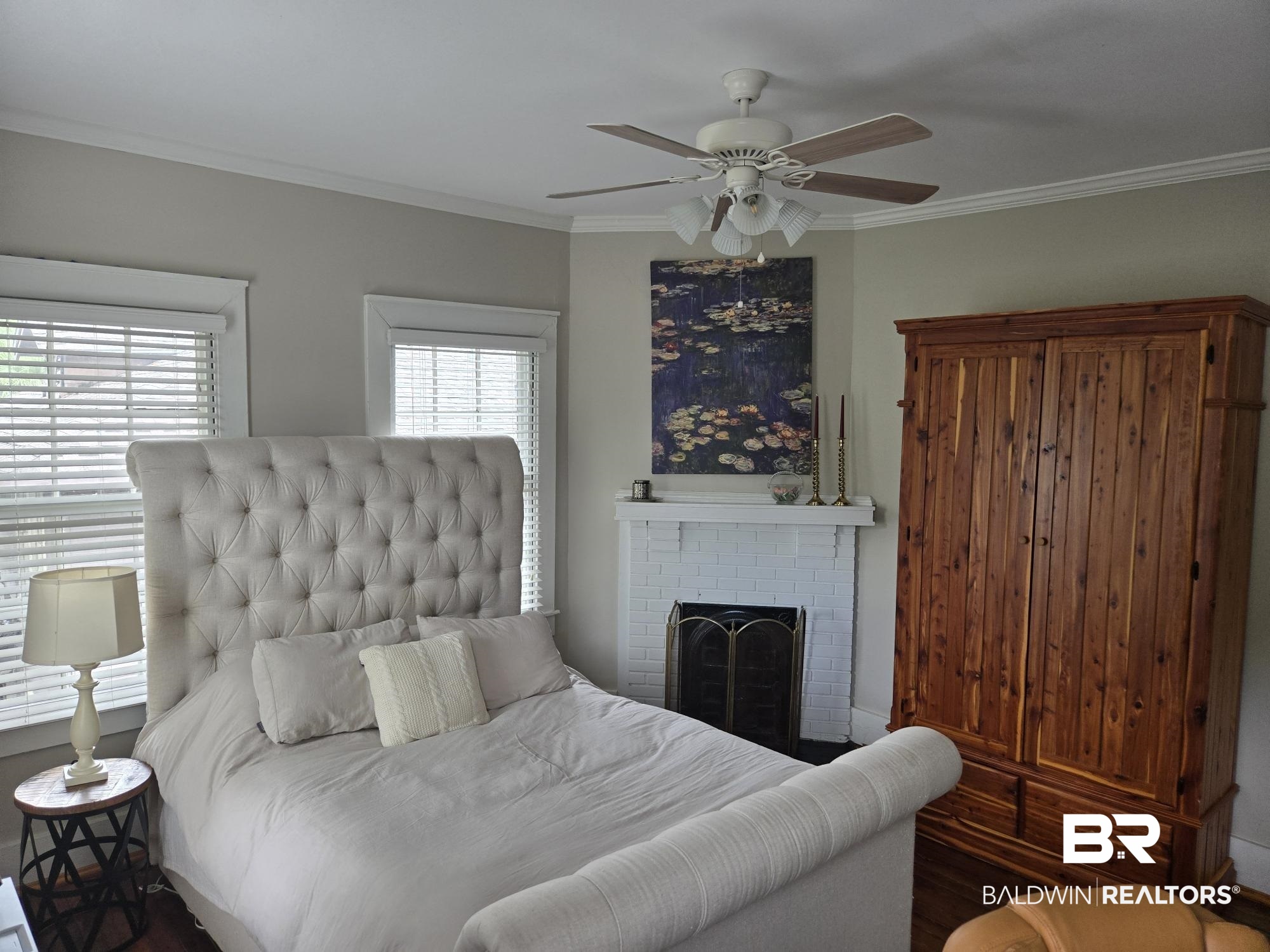 54 South Catherine Street Mobile, AL 36604 - Photo 35 of 55 Bedroom featuring crown molding, wood finished floors, a brick fireplace, a ceiling fan, and baseboards