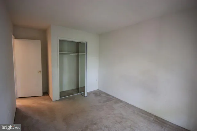 an empty room with closet and closet