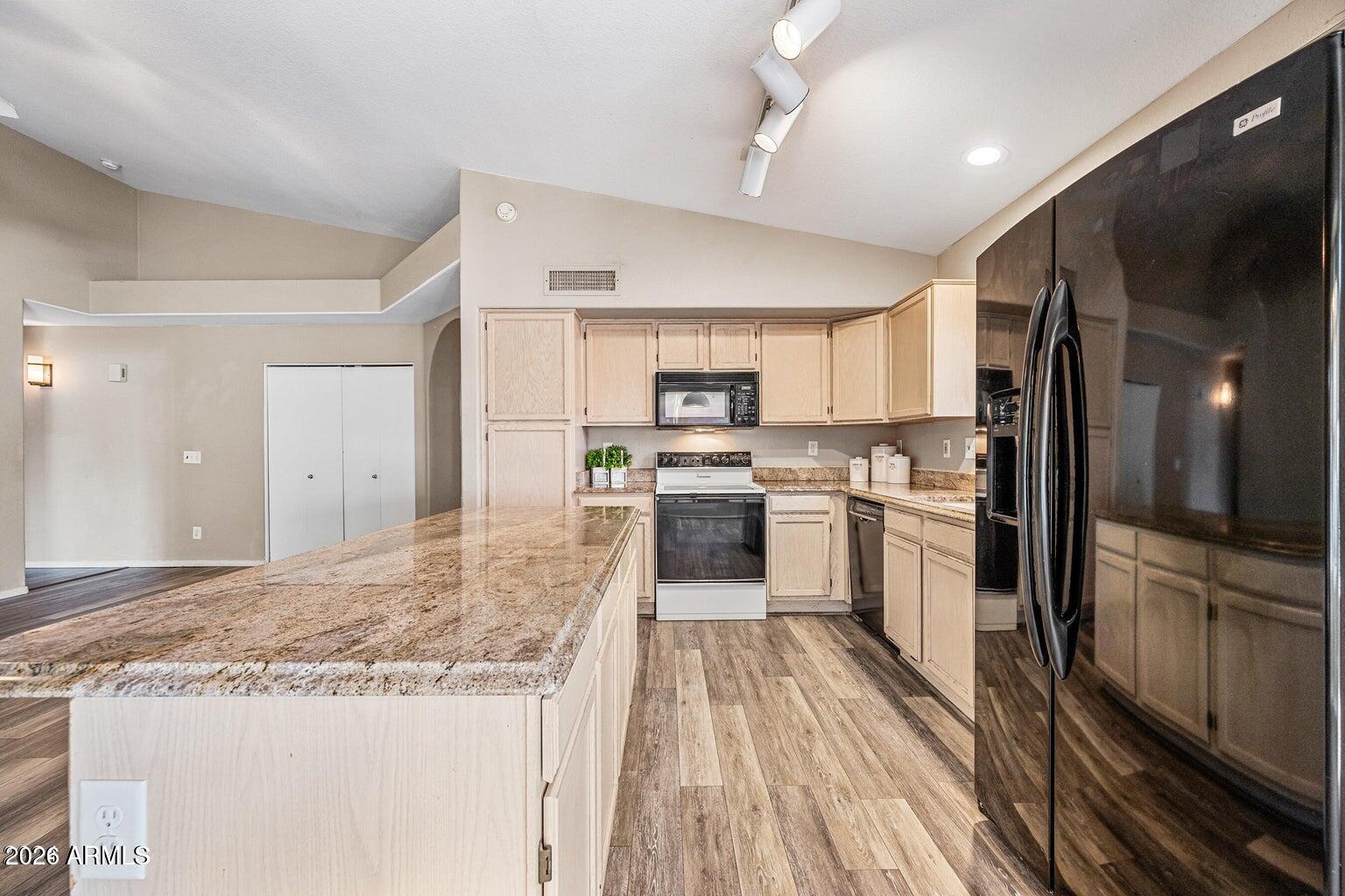 473 West Smoke Tree Road Gilbert, AZ 85233 - Photo 15 of 43 a kitchen with granite countertop a refrigerator stove top oven and sink