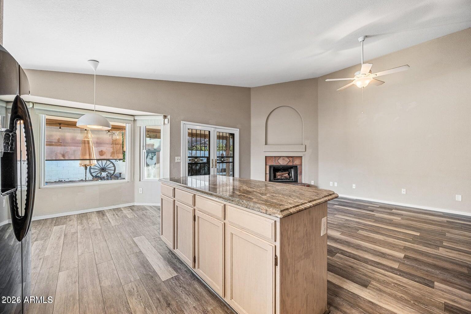 473 West Smoke Tree Road Gilbert, AZ 85233 - Photo 18 of 43 a view of a kitchen with a sink wooden cabinets and a floor to ceiling window