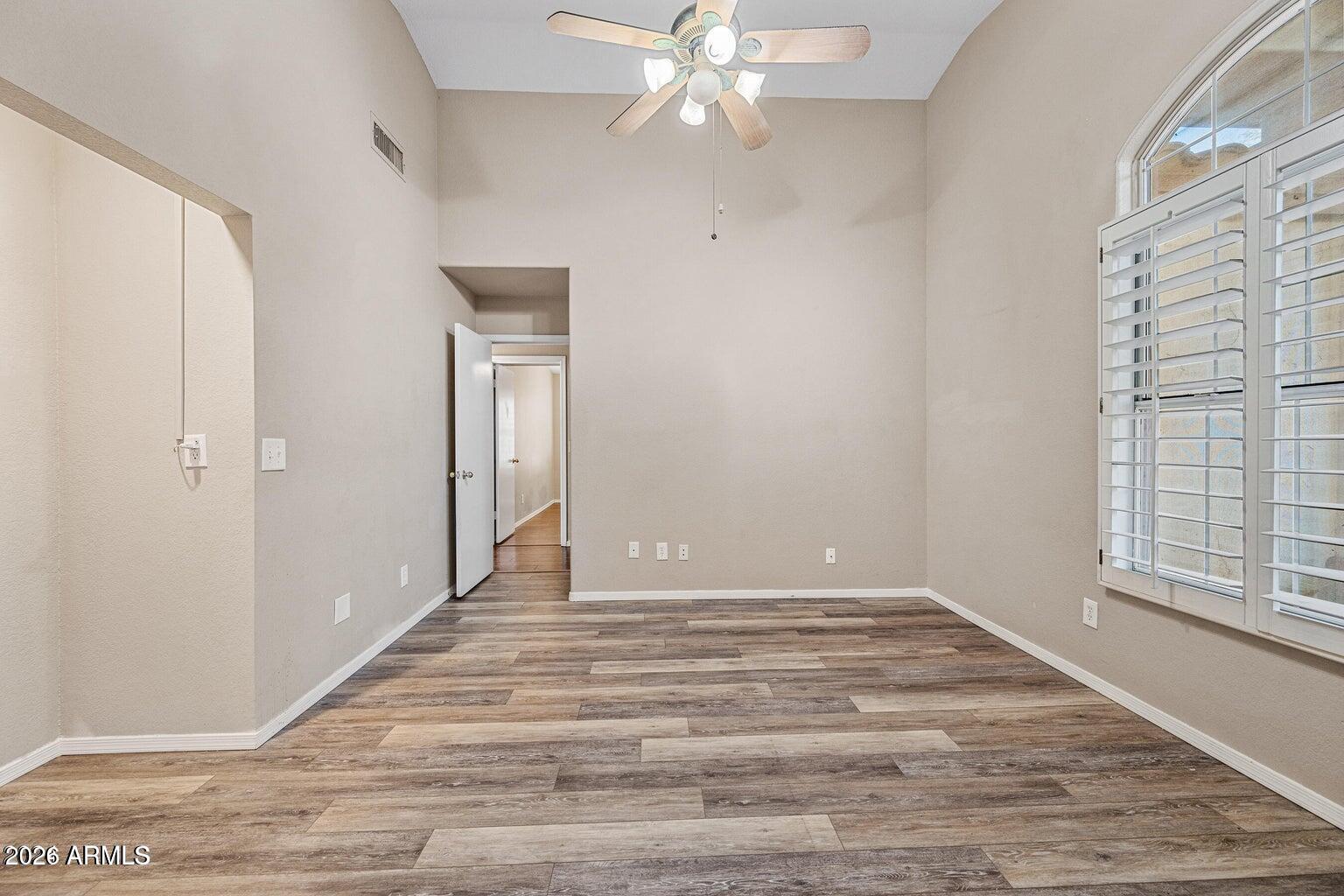 473 West Smoke Tree Road Gilbert, AZ 85233 - Photo 32 of 43 a view of an empty room with wooden floor and a window