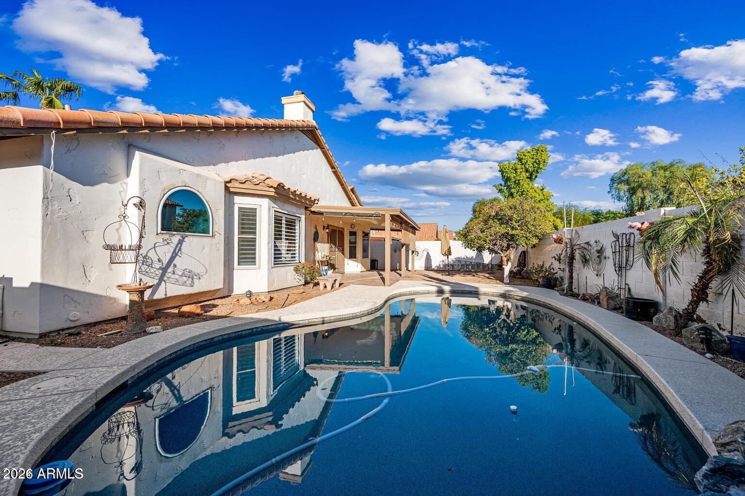 473 West Smoke Tree Road Gilbert, AZ 85233 - Photo 35 of 43 a house view with a seating space and a potted plant