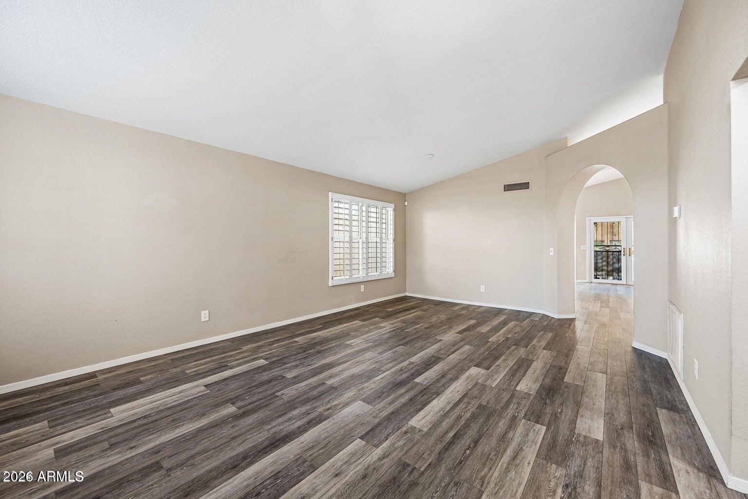 473 West Smoke Tree Road Gilbert, AZ 85233 - Photo 5 of 43 wooden floor in an empty room with a window