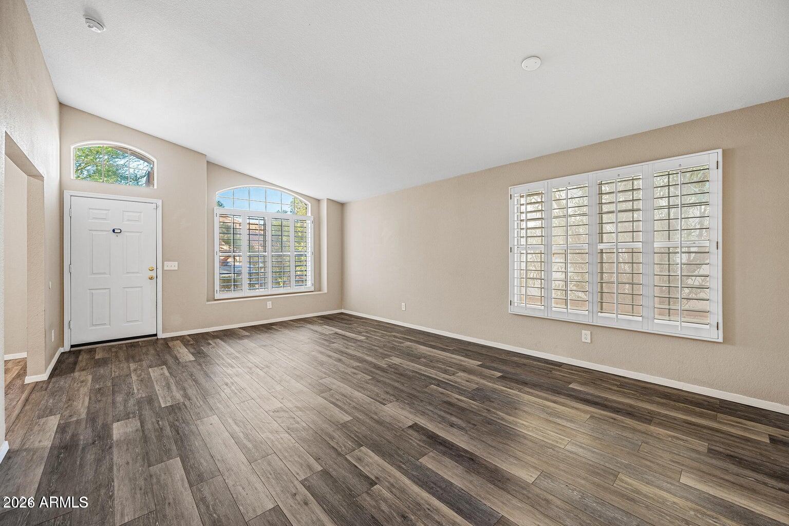 473 West Smoke Tree Road Gilbert, AZ 85233 - Photo 6 of 43 a view of an empty room with wooden floor and a window