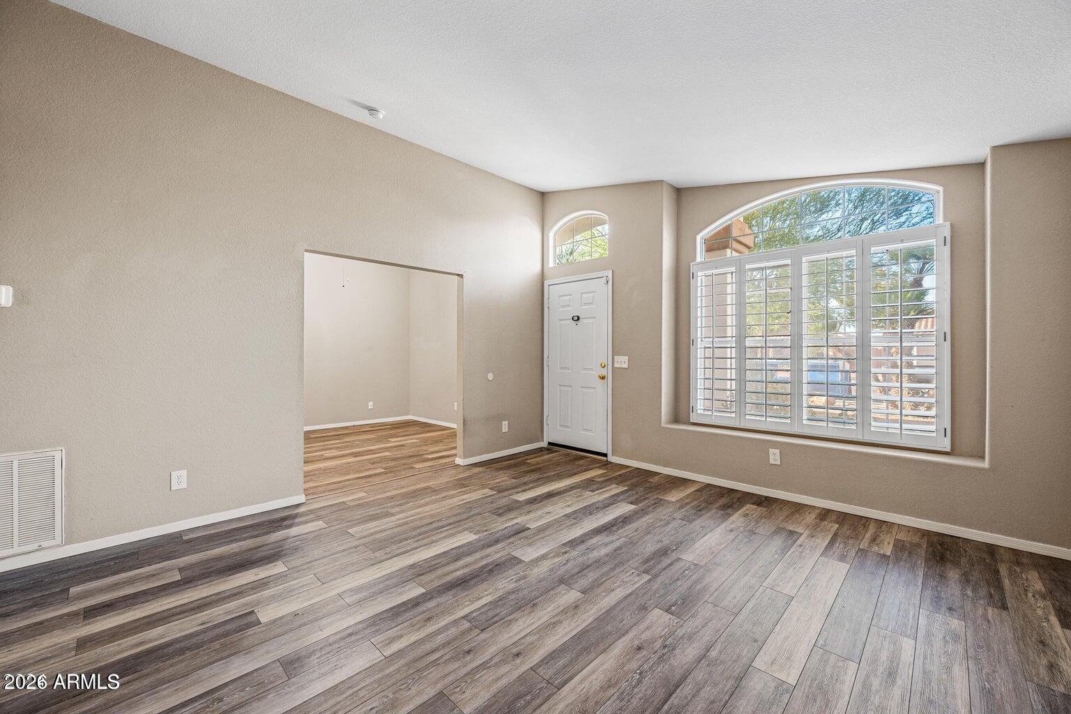 473 West Smoke Tree Road Gilbert, AZ 85233 - Photo 7 of 43 a view of an empty room with wooden floor and a window