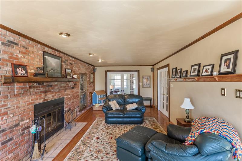 3835 Hills Church Road Export, PA 15632 - Photo 8 of 25 Family room with hard wood floors. Wood burning fireplace with gas starter.
