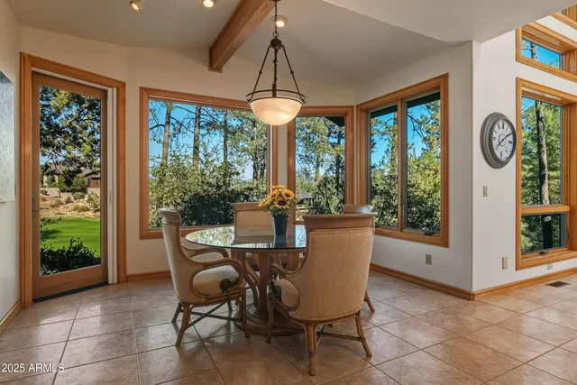 a spacious bedroom with a bed couch and a large window
