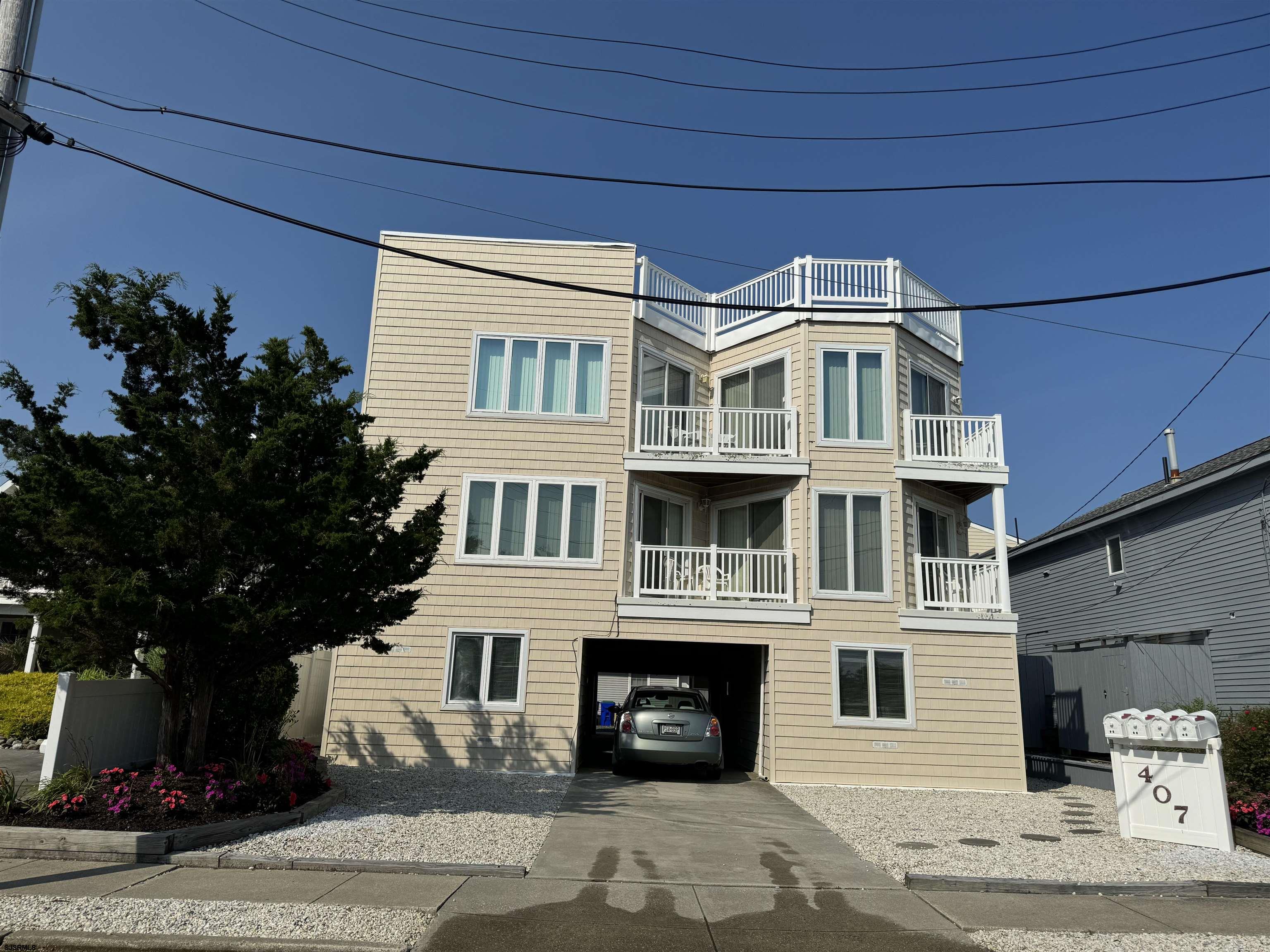 407 36th Street South, Unit 2 Brigantine, NJ 08203 - Photo 1 of 30 a front view of a house with a tree