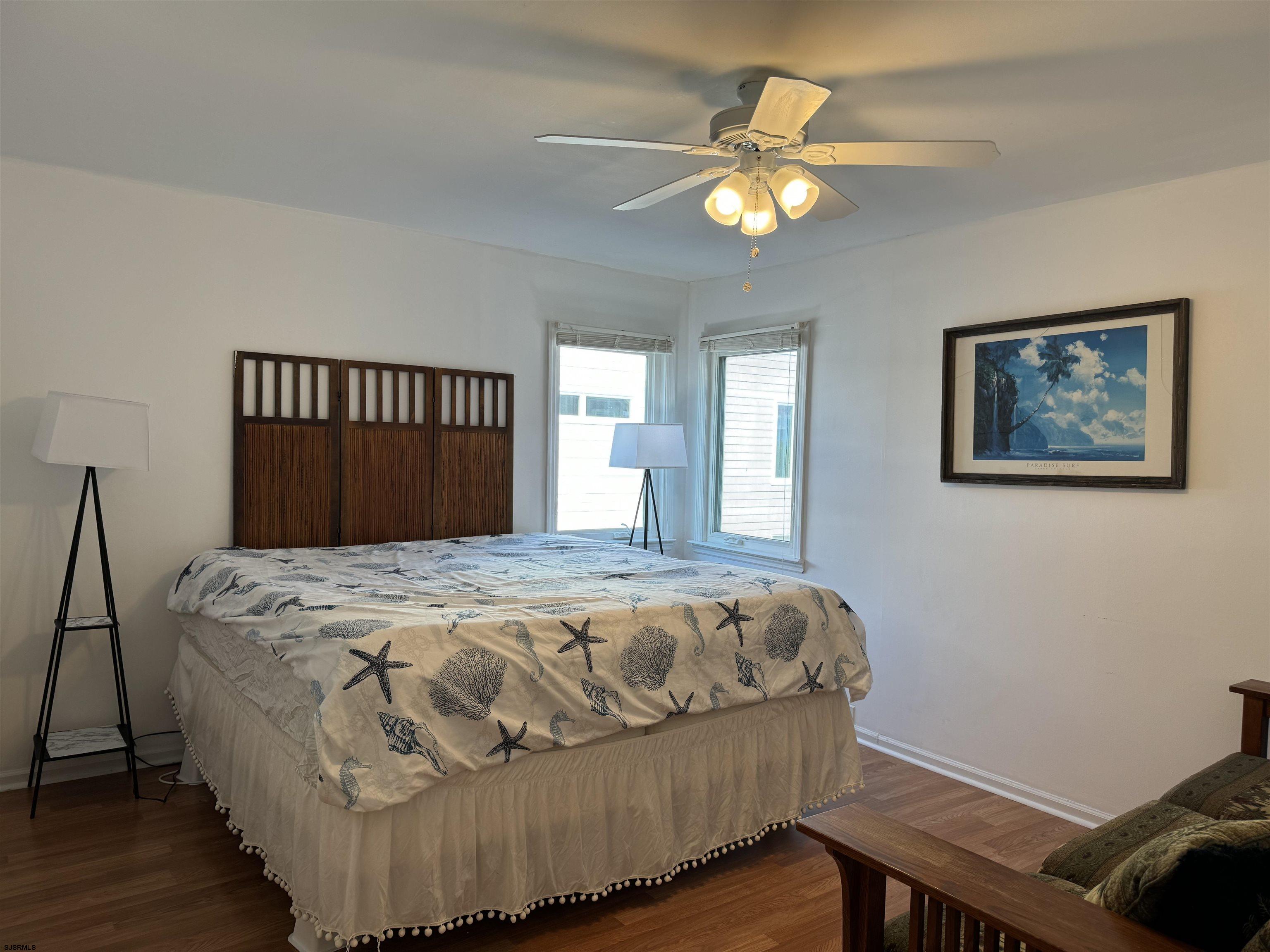 407 36th Street South, Unit 2 Brigantine, NJ 08203 - Photo 11 of 30 a bedroom with a bed and a chandelier