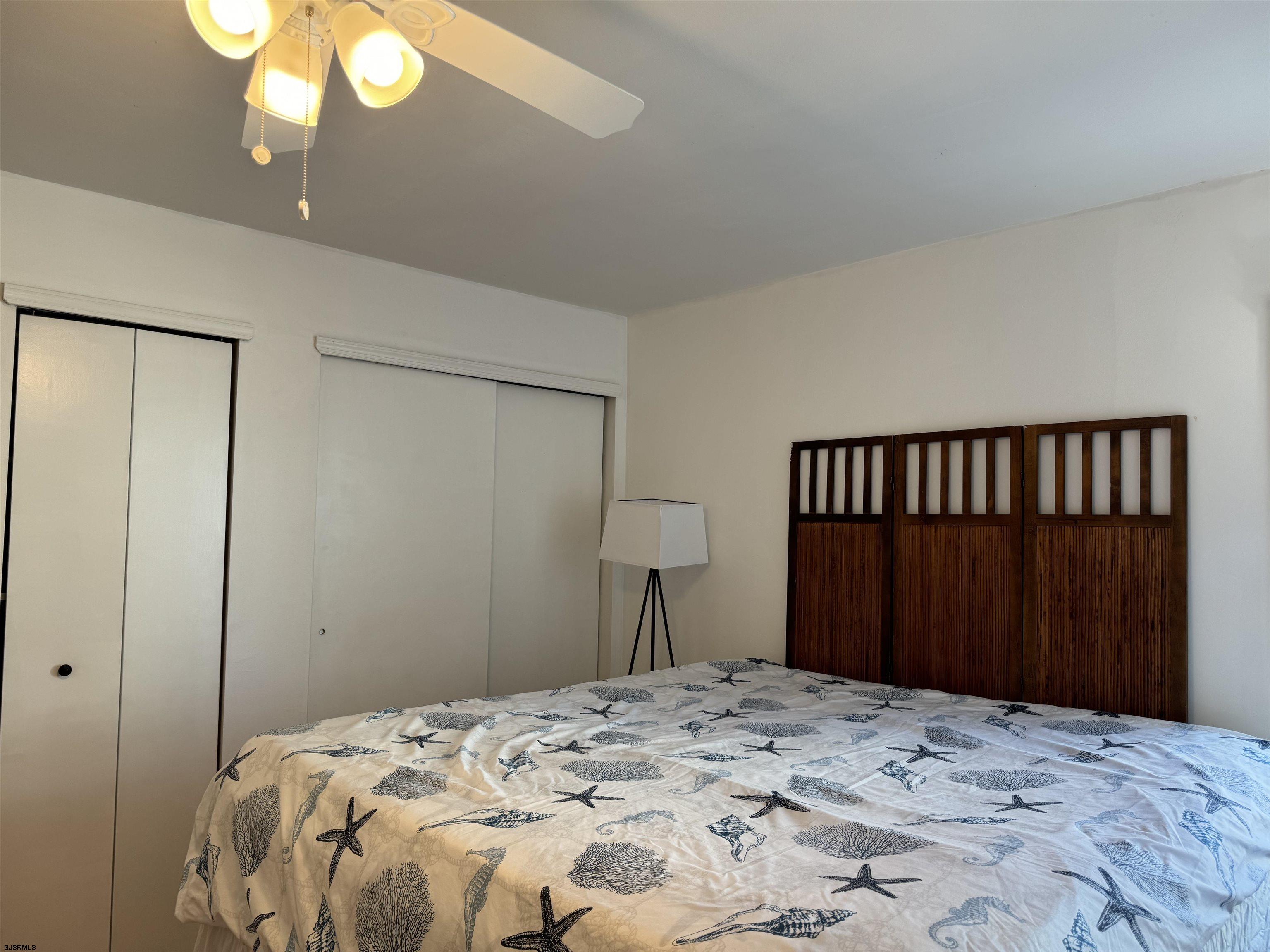 407 36th Street South, Unit 2 Brigantine, NJ 08203 - Photo 12 of 30 a bedroom with a bed and a mirror