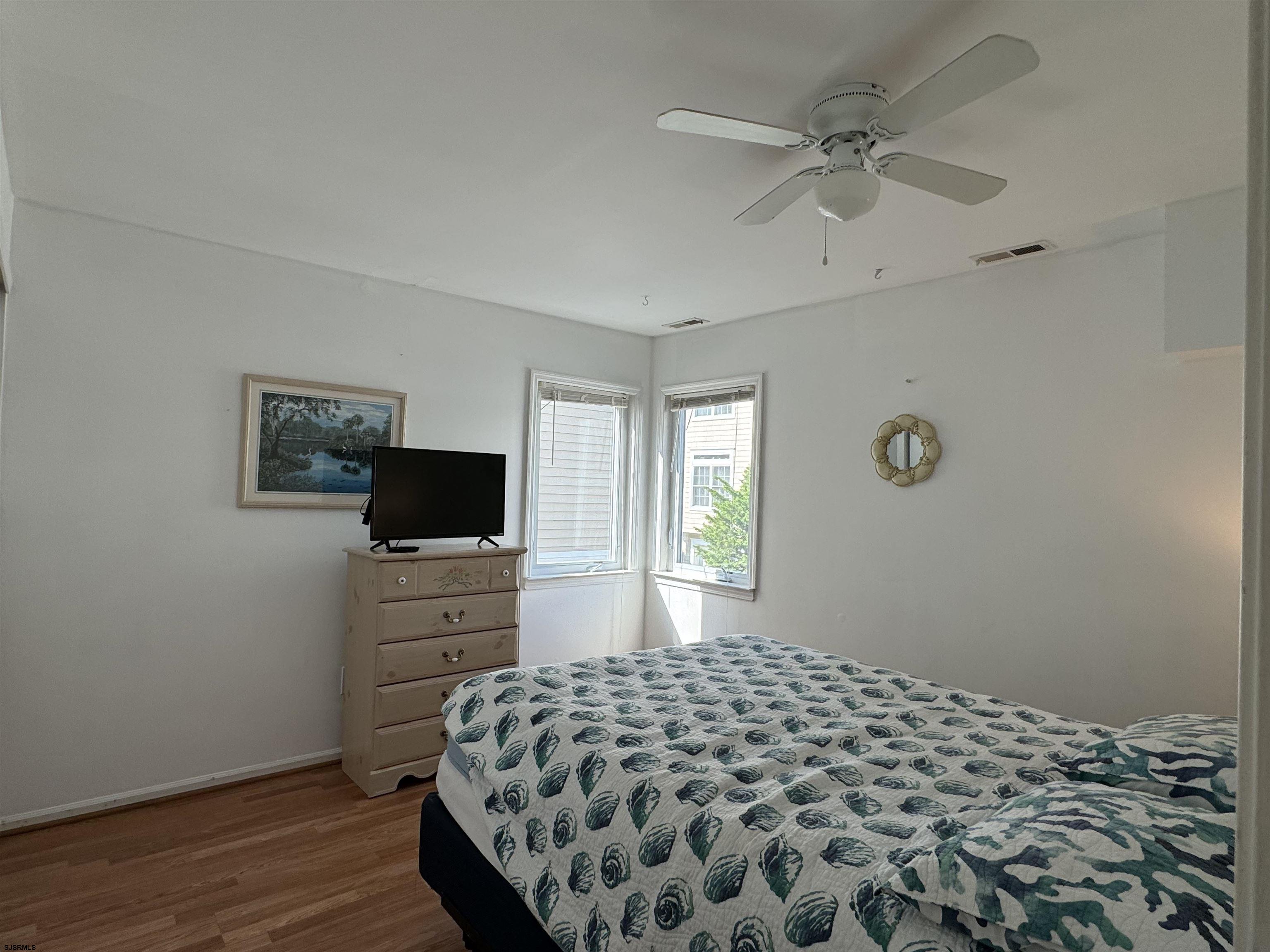 407 36th Street South, Unit 2 Brigantine, NJ 08203 - Photo 17 of 30 a bedroom with a bed and a flat screen tv