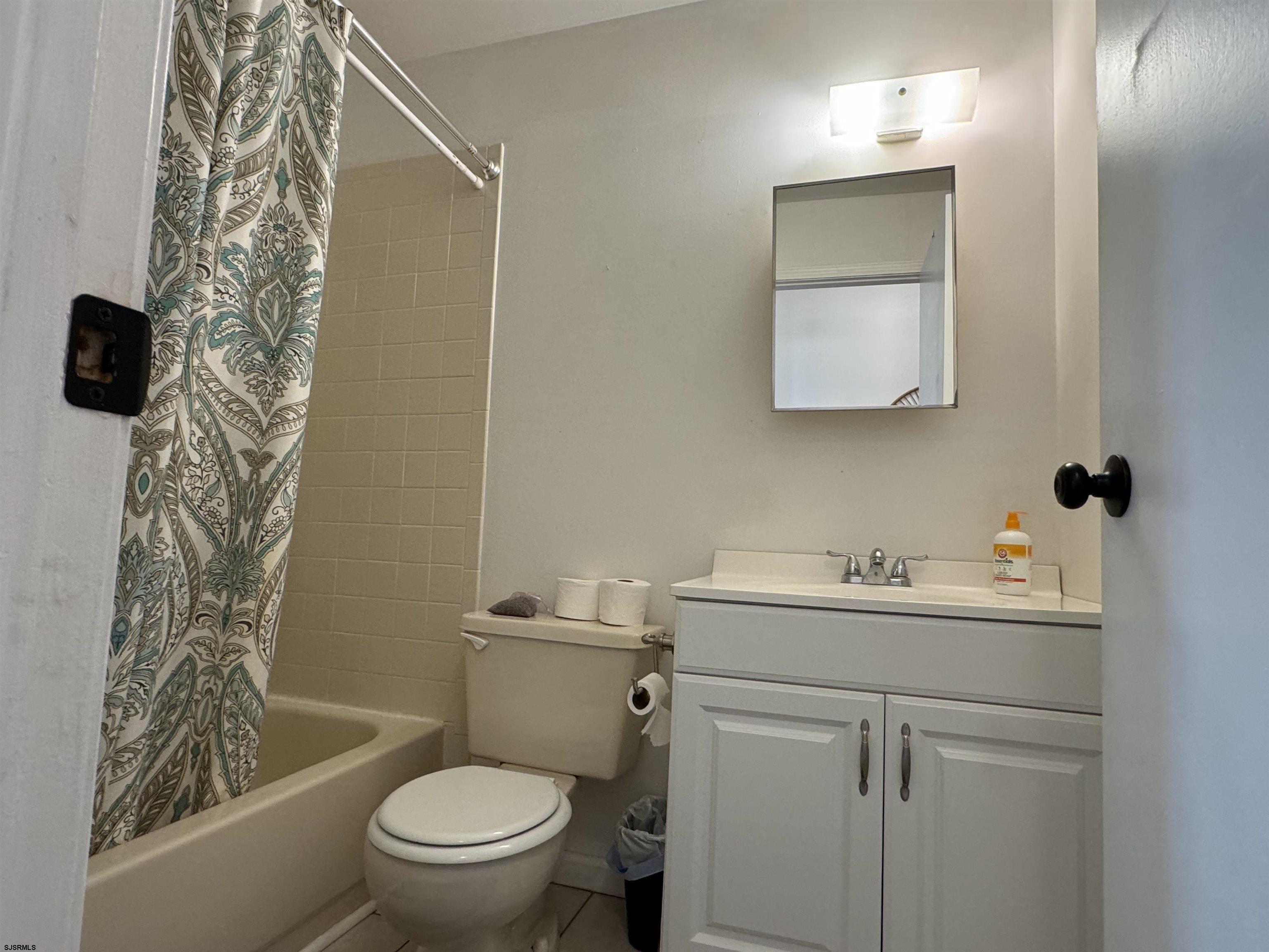 407 36th Street South, Unit 2 Brigantine, NJ 08203 - Photo 19 of 30 a bathroom with a toilet sink and mirror