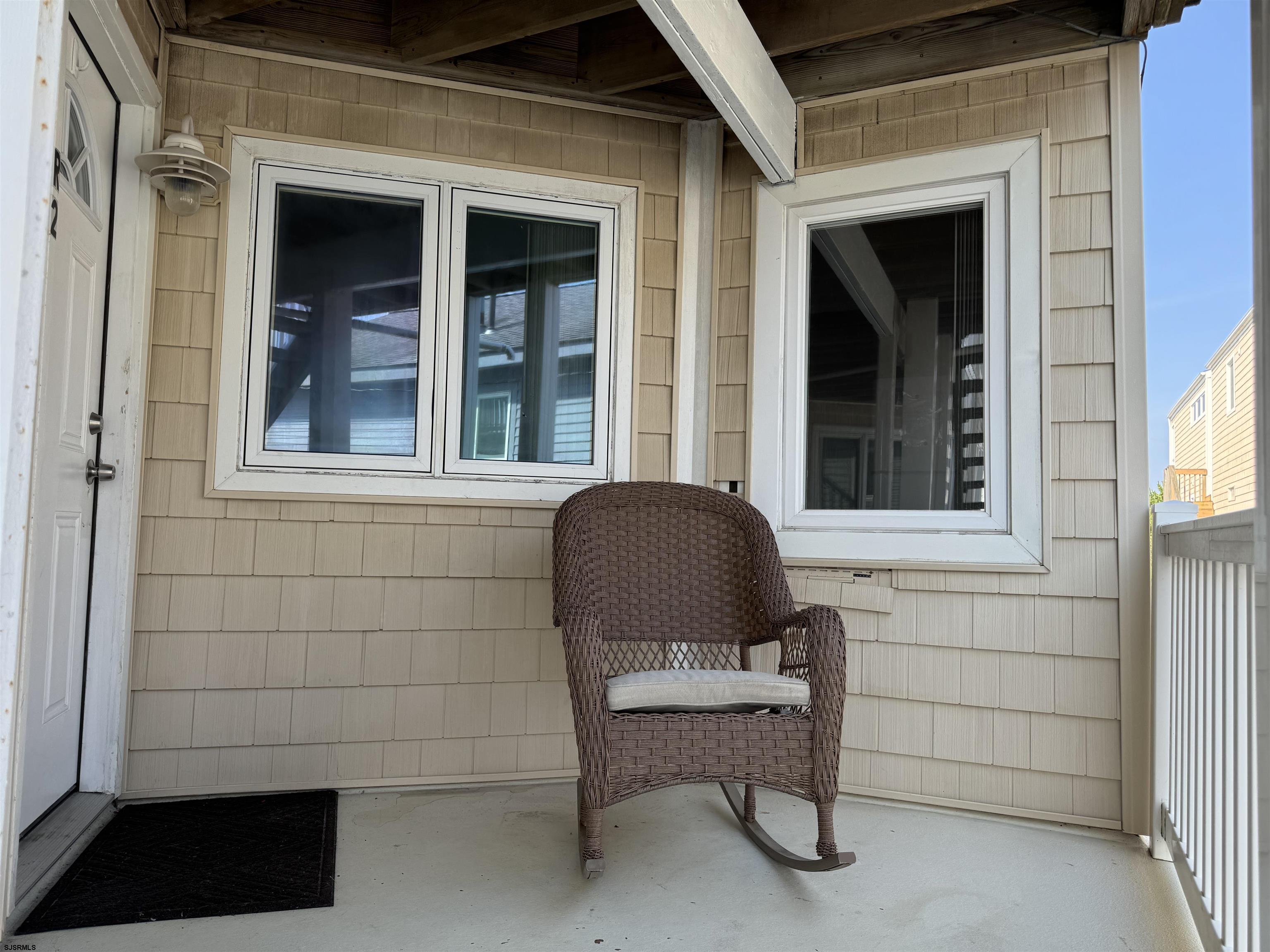 407 36th Street South, Unit 2 Brigantine, NJ 08203 - Photo 2 of 30 a chair and a table in a balcony