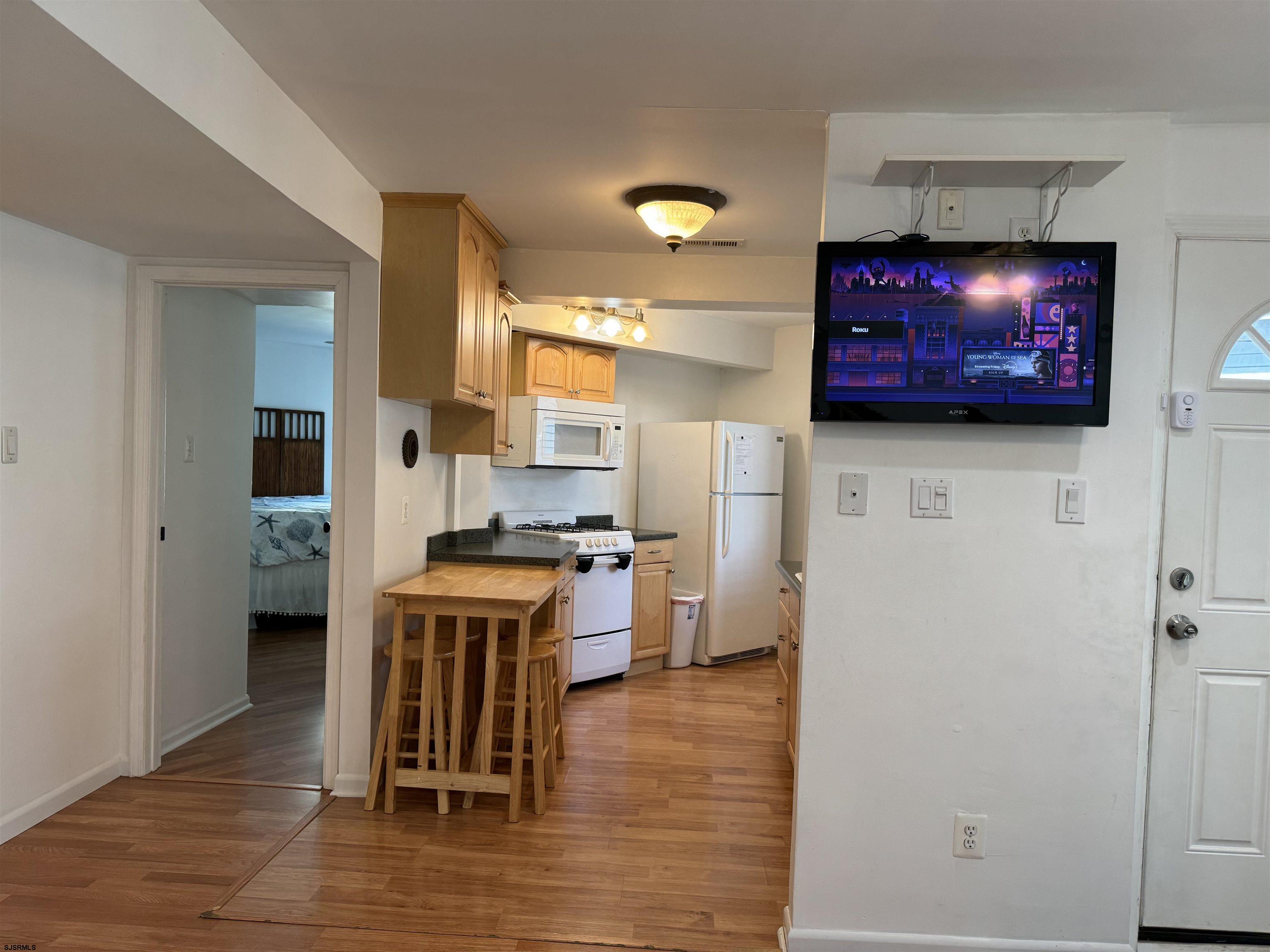 407 36th Street South, Unit 2 Brigantine, NJ 08203 - Photo 7 of 30 a kitchen with stainless steel appliances a stove top oven a sink and a refrigerator
