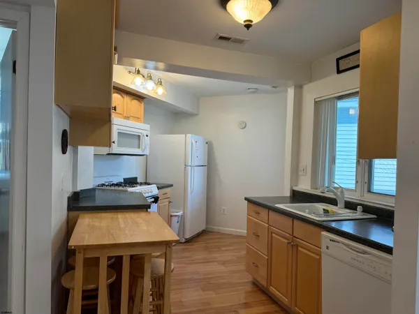 a kitchen with a sink stove and refrigerator