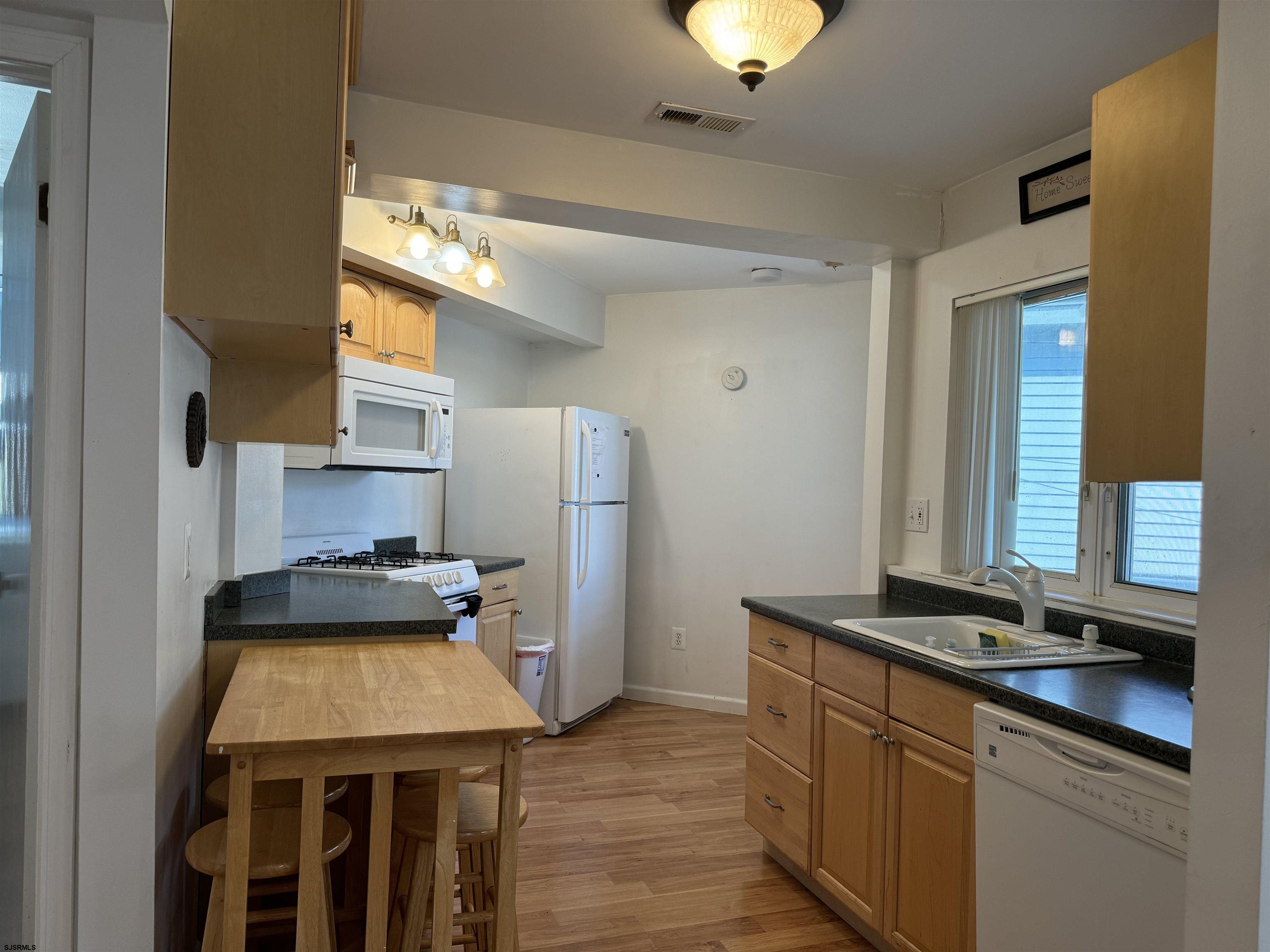 407 36th Street South, Unit 2 Brigantine, NJ 08203 - Photo 8 of 30 a kitchen with a sink stove and refrigerator