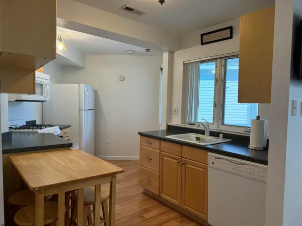 a kitchen with a stove a sink and a refrigerator